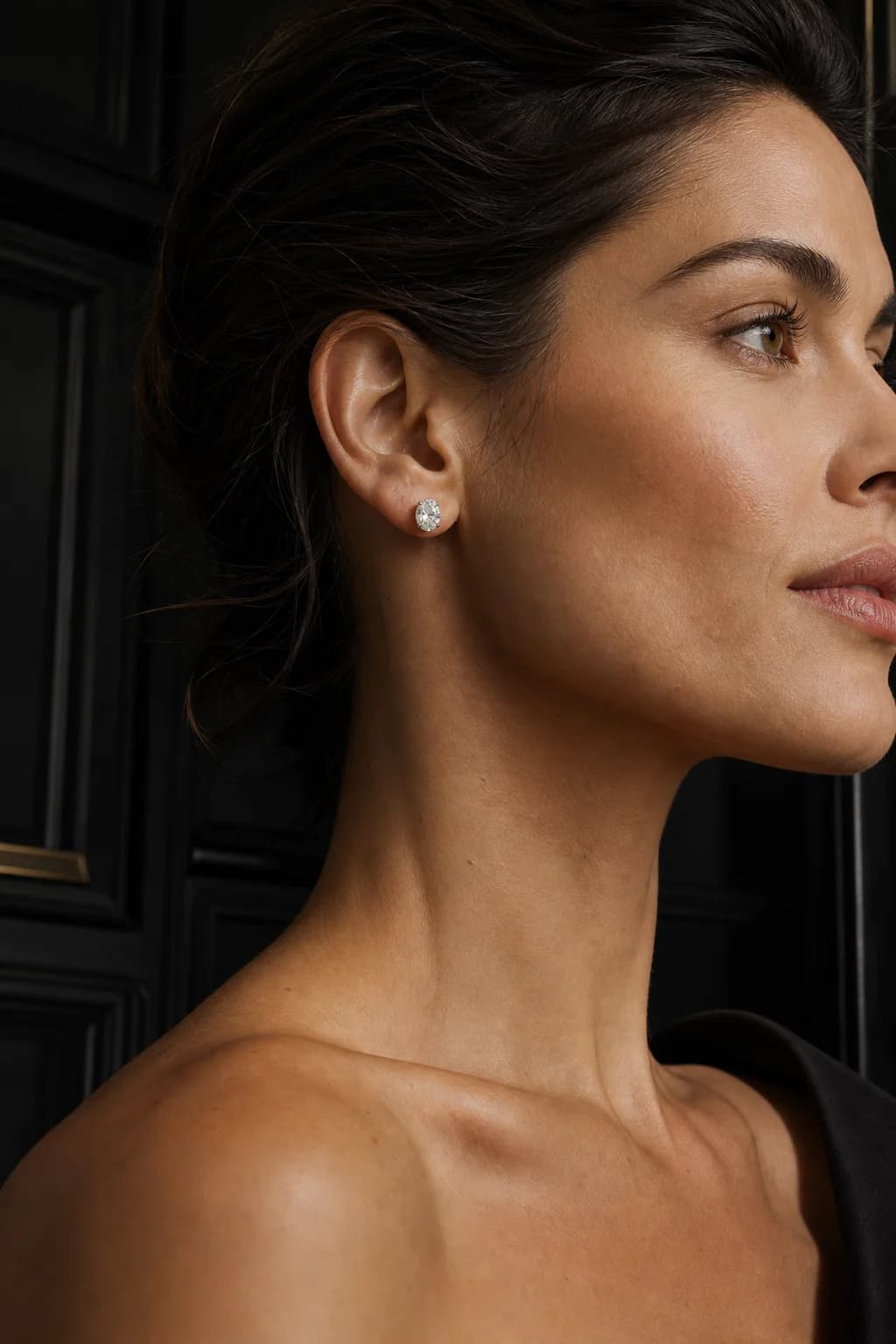 A poised woman wearing Dauntless oval diamond studs
